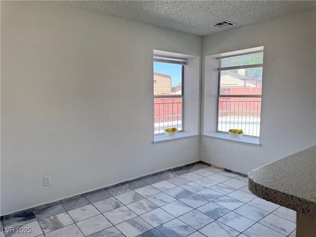 5600 Grossmont Ave, Las Vegas, NV 89110 - spare room with a textured ceiling and light tile patterned flooring