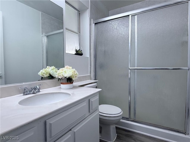 5600 Grossmont Ave, Las Vegas, NV 89110 - bathroom featuring toilet, vanity, wood finished floors, and an enclosed shower