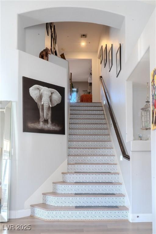 2549 Sundew Ave, Henderson, NV 89052 - staircase featuring baseboards and arched walkways