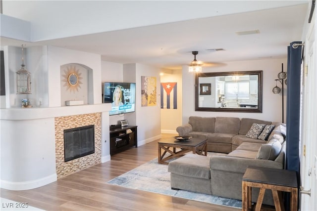 2549 Sundew Ave, Henderson, NV 89052 - living area with baseboards, wood finished floors, a fireplace, and ceiling fan