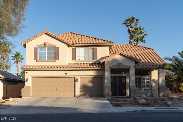 2549 Sundew Ave, Henderson, NV 89052 - mediterranean / spanish house featuring stucco siding, a garage, concrete driveway, and a tile roof