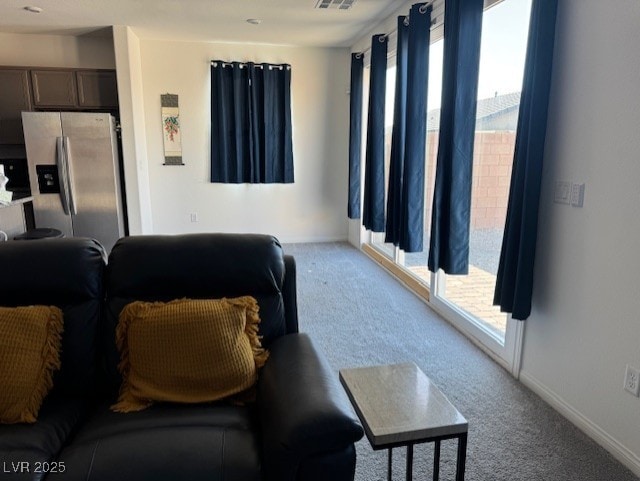 411 Hellebores Ave, North Las Vegas, NV 89084 - carpeted living area featuring healthy amount of natural light and baseboards