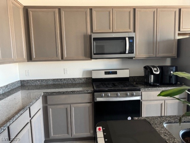 411 Hellebores Ave, North Las Vegas, NV 89084 - kitchen featuring appliances with stainless steel finishes and dark stone counters