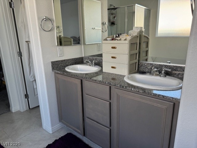 411 Hellebores Ave, North Las Vegas, NV 89084 - bathroom featuring a stall shower, tile patterned flooring, and double vanity