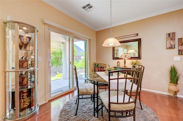 2545 Nashira St, Henderson, NV 89044 - dining room with wood finished floors, crown molding, and baseboards