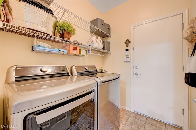 2545 Nashira St, Henderson, NV 89044 - laundry area with washing machine and clothes dryer, light tile patterned floors, and baseboards