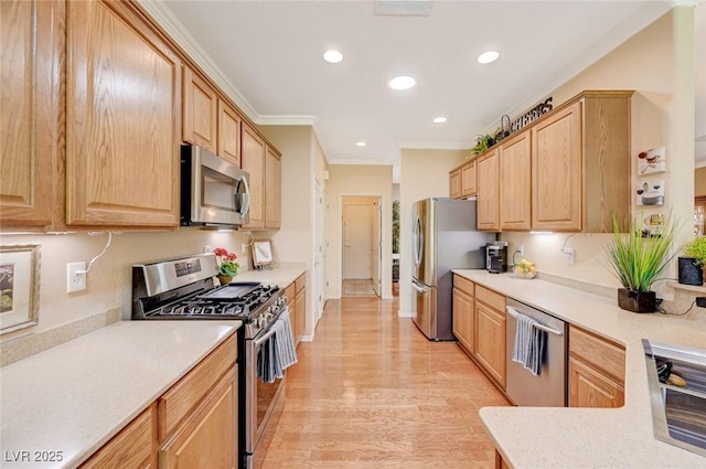 2545 Nashira St, Henderson, NV 89044 - kitchen with stainless steel appliances, light brown cabinetry, crown molding, light countertops, and recessed lighting