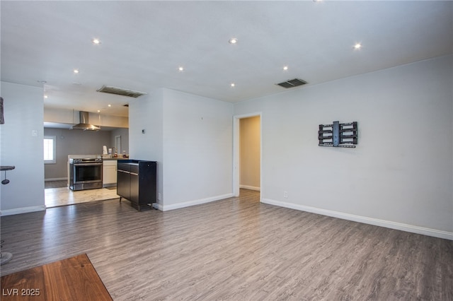 237 Cervantes St, Las Vegas, NV 89101 - unfurnished living room with light wood-style flooring, baseboards, and recessed lighting