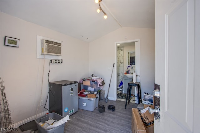 237 Cervantes St, Las Vegas, NV 89101 - interior space featuring lofted ceiling, wood finished floors, an AC wall unit, track lighting, and baseboards