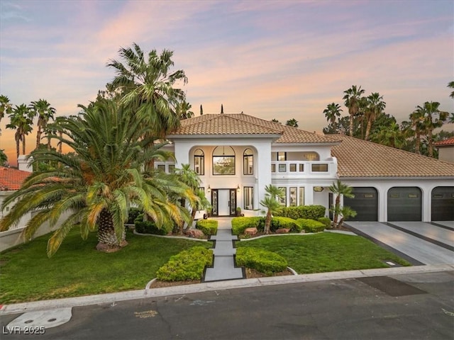 21 Sawgrass Ct, Las Vegas, NV 89113 - mediterranean / spanish-style home featuring a front lawn, an attached garage, driveway, and a tile roof