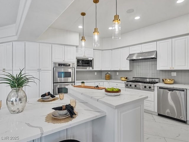21 Sawgrass Ct, Las Vegas, NV 89113 - kitchen featuring stainless steel appliances, under cabinet range hood, light marble finish flooring, white cabinets, and light stone counters