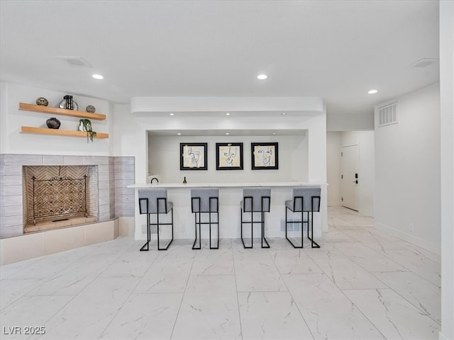 21 Sawgrass Ct, Las Vegas, NV 89113 - interior space with recessed lighting, a fireplace, light marble finish flooring, and baseboards
