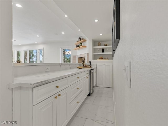 21 Sawgrass Ct, Las Vegas, NV 89113 - kitchen with open shelves, light marble finish floors, white cabinets, recessed lighting, and light stone countertops