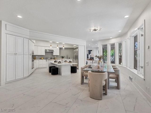 21 Sawgrass Ct, Las Vegas, NV 89113 - dining area with light marble finish flooring and recessed lighting