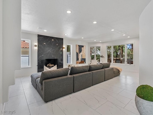 21 Sawgrass Ct, Las Vegas, NV 89113 - living area featuring marble finish flooring, a high end fireplace, and recessed lighting