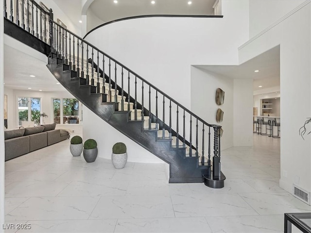 21 Sawgrass Ct, Las Vegas, NV 89113 - staircase featuring marble finish flooring, a high ceiling, recessed lighting, and baseboards