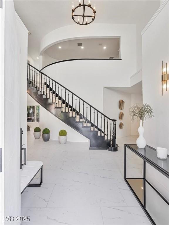 21 Sawgrass Ct, Las Vegas, NV 89113 - entrance foyer with marble finish flooring, stairway, and a chandelier