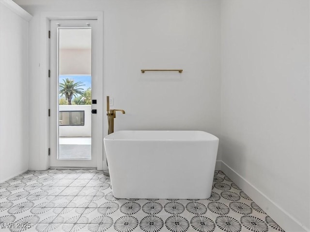 21 Sawgrass Ct, Las Vegas, NV 89113 - bathroom featuring a freestanding tub and baseboards