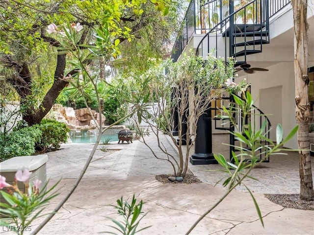 21 Sawgrass Ct, Las Vegas, NV 89113 - view of patio / terrace with an outdoor fire pit, stairs, and ceiling fan