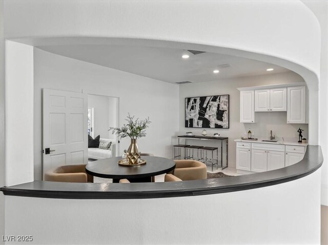 21 Sawgrass Ct, Las Vegas, NV 89113 - interior space featuring a sink, recessed lighting, white cabinets, and dark countertops