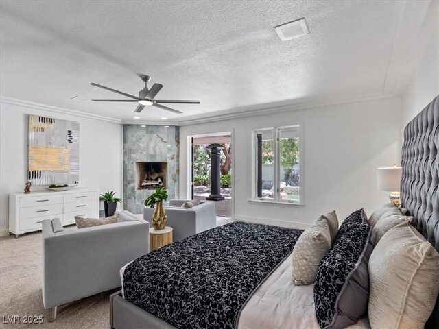 21 Sawgrass Ct, Las Vegas, NV 89113 - bedroom with ornamental molding, light colored carpet, access to exterior, a premium fireplace, and a ceiling fan