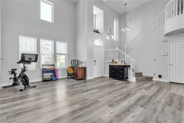 9585 Teton Diablo Ave, Las Vegas, NV 89117 - entryway with a high ceiling, healthy amount of natural light, stairway, baseboards, and wood finished floors