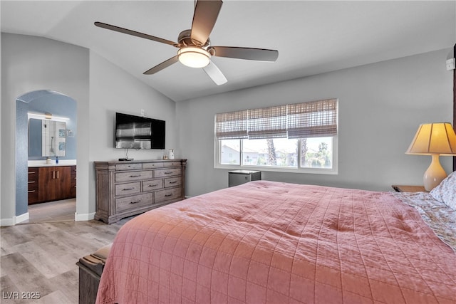 9585 Teton Diablo Ave, Las Vegas, NV 89117 - bedroom featuring vaulted ceiling, light wood finished floors, arched walkways, ceiling fan, and baseboards