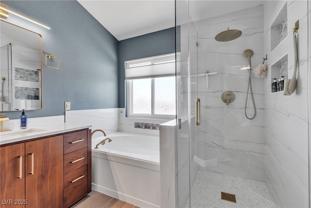 9585 Teton Diablo Ave, Las Vegas, NV 89117 - bathroom featuring a marble finish shower, vanity, a garden tub, and a textured wall