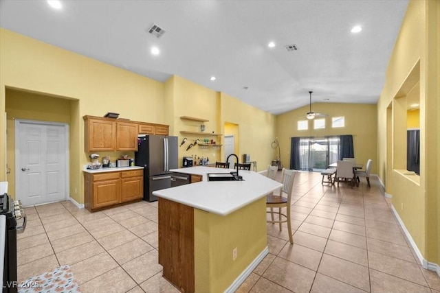 4308 Brazil Palm Ct, North Las Vegas, NV 89032 - kitchen featuring freestanding refrigerator, a sink, light countertops, vaulted ceiling, and light tile patterned flooring