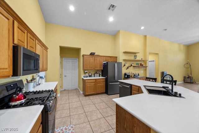 4308 Brazil Palm Ct, North Las Vegas, NV 89032 - kitchen with gas stove, freestanding refrigerator, a sink, dishwashing machine, and light countertops