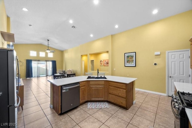 4308 Brazil Palm Ct, North Las Vegas, NV 89032 - kitchen with stainless steel appliances, vaulted ceiling, ceiling fan, a sink, and light countertops