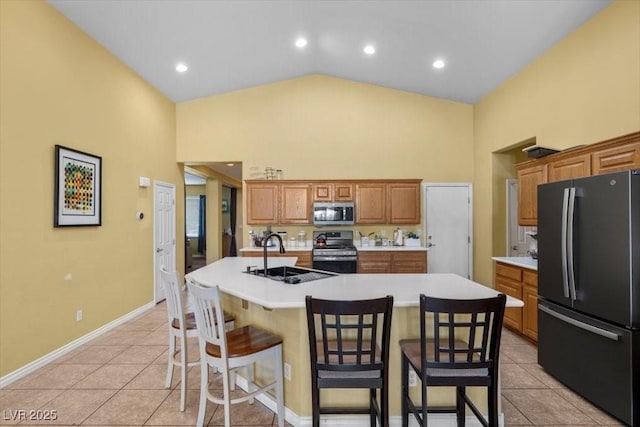 4308 Brazil Palm Ct, North Las Vegas, NV 89032 - kitchen featuring appliances with stainless steel finishes, a sink, high vaulted ceiling, light tile patterned floors, and a kitchen breakfast bar