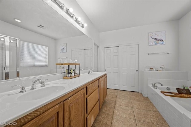 4308 Brazil Palm Ct, North Las Vegas, NV 89032 - full bathroom featuring double vanity, a garden tub, and tile patterned flooring