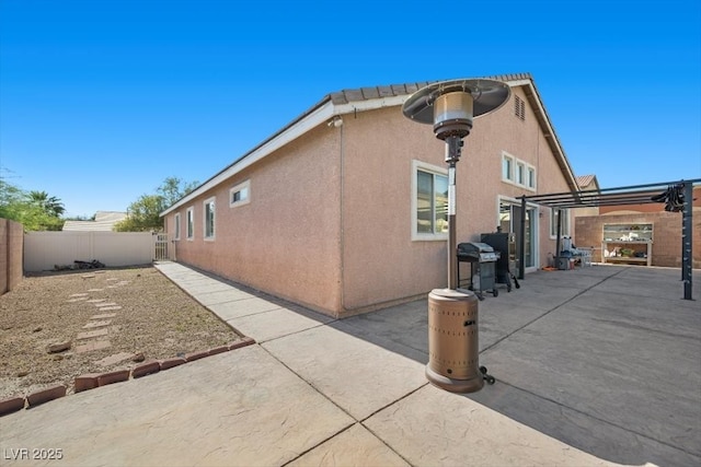 4308 Brazil Palm Ct, North Las Vegas, NV 89032 - view of side of home featuring a patio area, a fenced backyard, stucco siding, and a pergola
