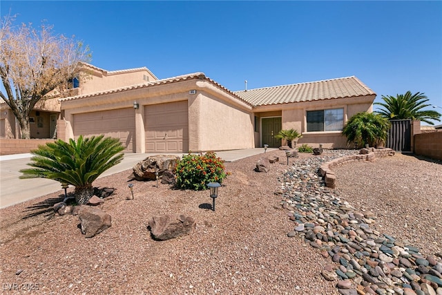 945 Stetson Dr, Henderson, NV 89002 - view of front of home featuring an attached garage, a tile roof, and stucco siding