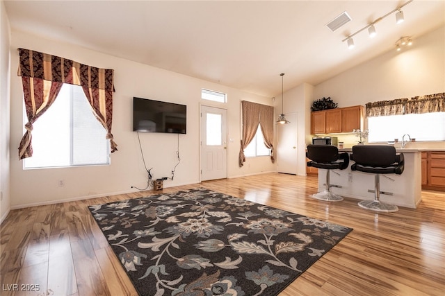 945 Stetson Dr, Henderson, NV 89002 - living area with light wood-type flooring, lofted ceiling, and baseboards