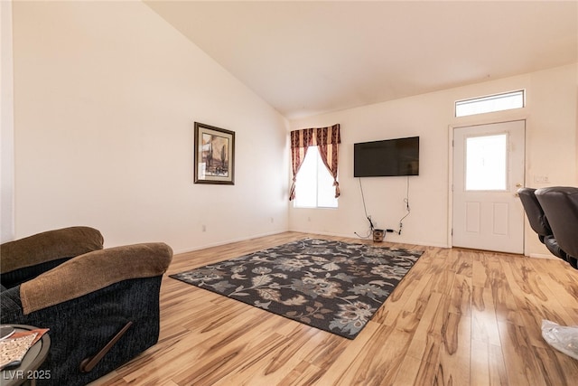945 Stetson Dr, Henderson, NV 89002 - living room featuring wood finished floors, healthy amount of natural light, and vaulted ceiling