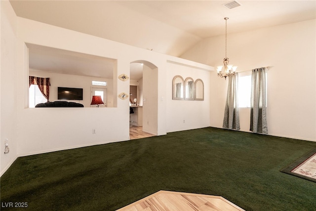 945 Stetson Dr, Henderson, NV 89002 - unfurnished living room with plenty of natural light, arched walkways, carpet floors, and vaulted ceiling