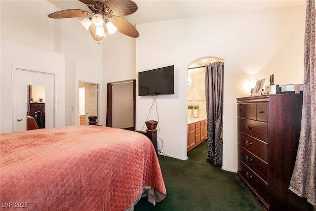 945 Stetson Dr, Henderson, NV 89002 - bedroom with dark colored carpet, connected bathroom, and ceiling fan