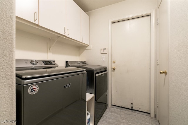 945 Stetson Dr, Henderson, NV 89002 - laundry room featuring washing machine and clothes dryer, cabinet space, and light wood finished floors