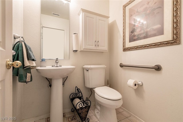 945 Stetson Dr, Henderson, NV 89002 - bathroom featuring toilet, baseboards, and tile patterned flooring