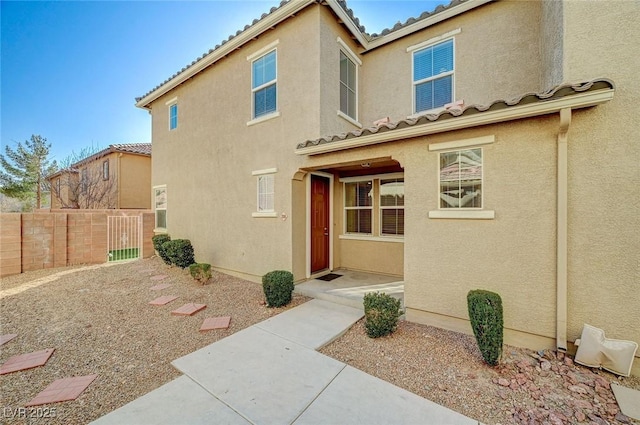 6255 W Arby Ave Unit 258, Las Vegas, NV 89118 - property entrance featuring a tile roof and stucco siding
