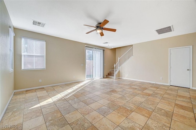 6255 W Arby Ave Unit 258, Las Vegas, NV 89118 - unfurnished room featuring stairs, ceiling fan, baseboards, and light stone finish floors