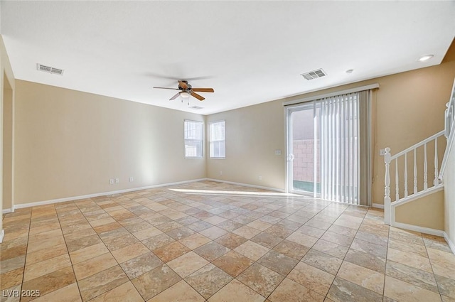 6255 W Arby Ave Unit 258, Las Vegas, NV 89118 - spare room featuring baseboards, ceiling fan, stone tile floors, and stairs