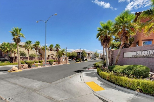 6255 W Arby Ave Unit 258, Las Vegas, NV 89118 - view of asphalt street with street lights, a residential view, curbs, and sidewalks