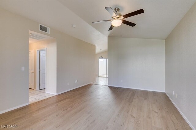 5424 Comchec Way Unit 105, Las Vegas, NV 89108 - unfurnished room featuring ceiling fan, light wood-style floors, lofted ceiling, and baseboards