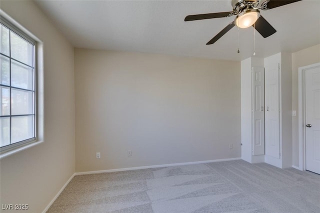 5424 Comchec Way Unit 105, Las Vegas, NV 89108 - unfurnished room featuring light colored carpet, healthy amount of natural light, a ceiling fan, and baseboards
