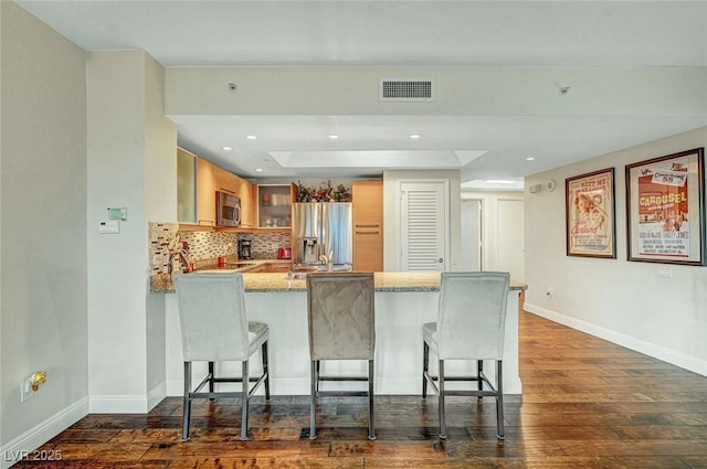 222 Karen Ave Unit 601, Las Vegas, NV 89109 - kitchen featuring stainless steel appliances, a peninsula, baseboards, dark wood-style floors, and recessed lighting