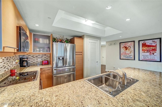 222 Karen Ave Unit 601, Las Vegas, NV 89109 - kitchen with stainless steel appliances, a sink, a raised ceiling, backsplash, and recessed lighting