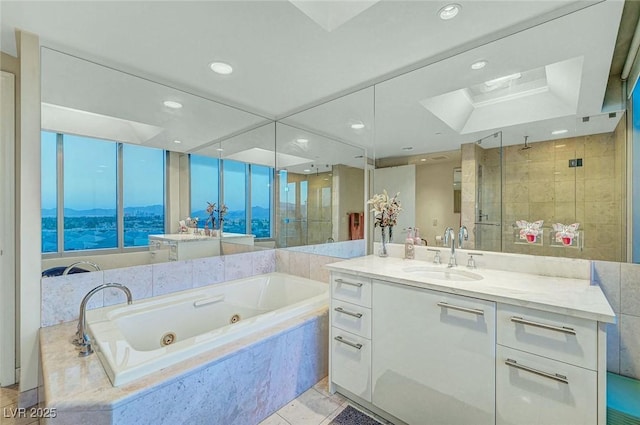 222 Karen Ave Unit 601, Las Vegas, NV 89109 - bathroom with a shower stall, a whirlpool tub, vanity, a skylight, and recessed lighting